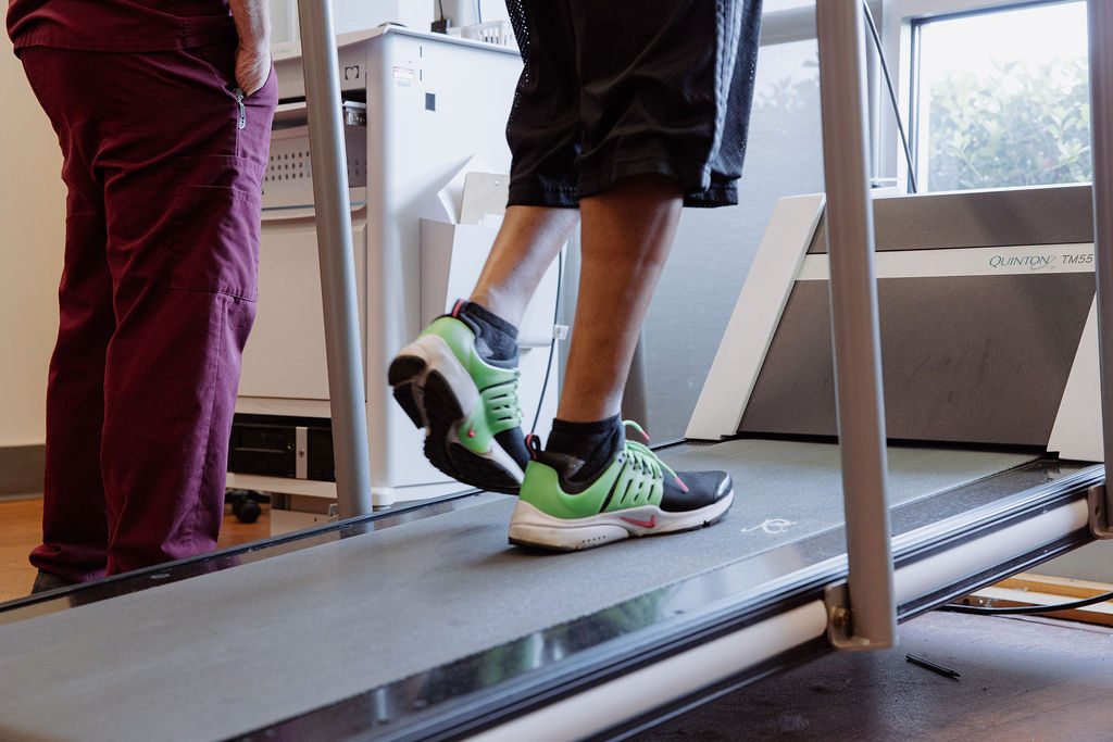 A Peripheral Vascular Disease (PVD) patient walks on a treadmill while a nurse looks on