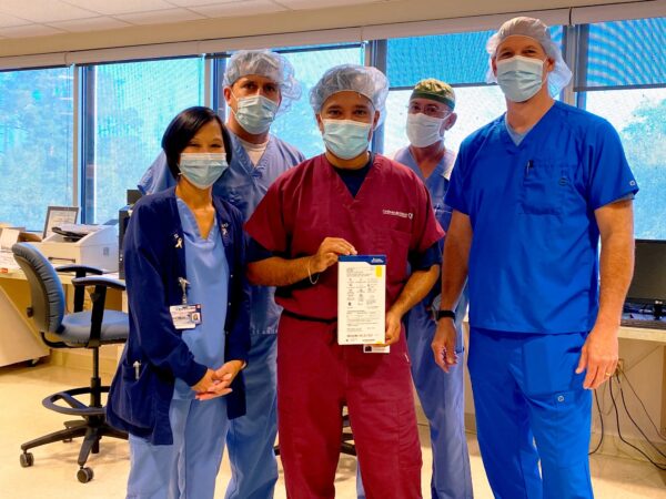 A group of CIS staff members poses with a box containing the LUX-Dx™ Insertable Cardiac Monitor (ICM) System