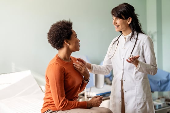 A compassionate cardiologist reassuring a patient during a consultation in a medical office.