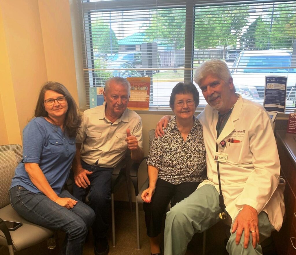 Dr. Peter Fail, cardiologist, poses with a group of patients