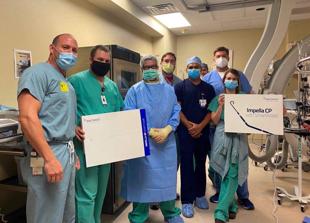 A group of CIS staff members pose with boxes containing the components for the Impella CP® and Impella RP®, the world’s smallest heart pump