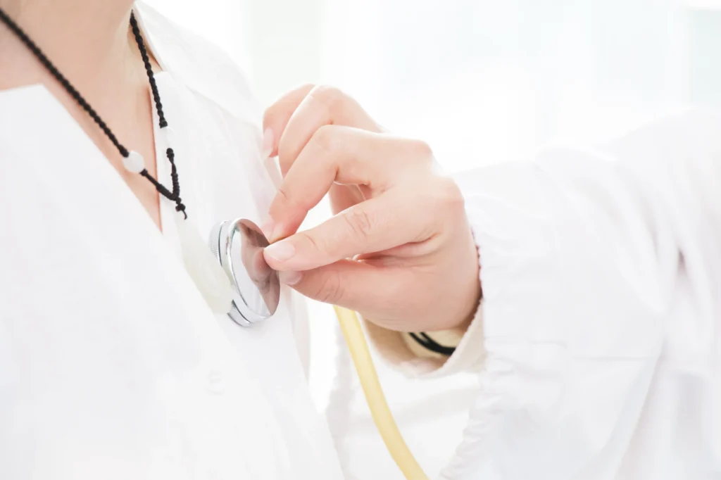 A heart doctor holding a stethoscope, ready for a medical examination.