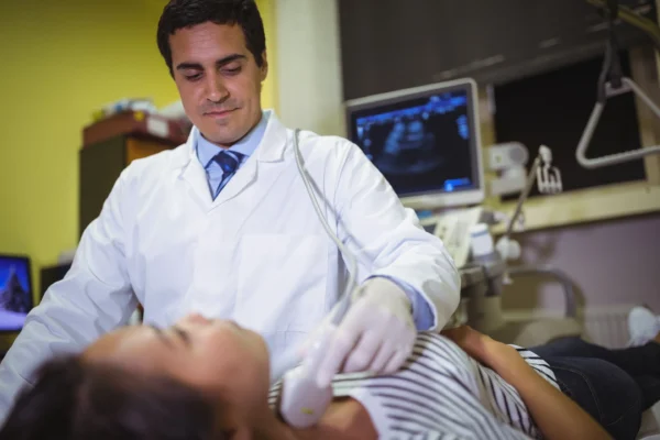 A healthcare professional at the Cardiovascular Institute of the South conducting an ultrasound examination on a patient.