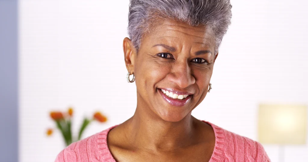 A cheerful senior woman with a warm smile, showcasing confidence and contentment, after receiving care at the Cardiovascular Institute of the South.