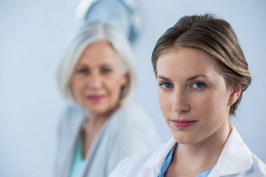 Confident cardiology professional in focus with a colleague in the background.