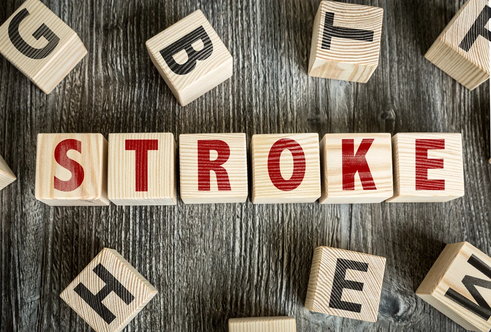 Wooden alphabet blocks spelling out the word "stroke" on a textured wooden background, signifying education or awareness about this medical condition related to cardiology.